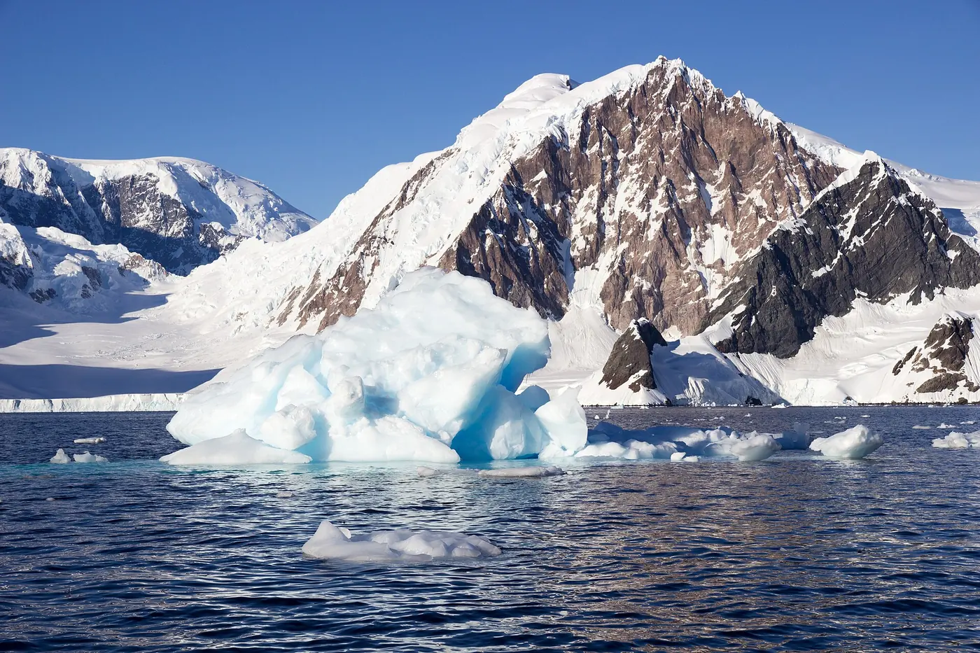 Photo: Gary Bembridge (CC BY 2.0) An iceberg below a rock peak in Paradise Bay
