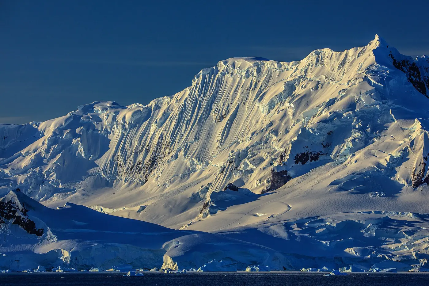 Photo: Murray Foubister (CC BY-SA 2.0) A glaciated peak rising from the sea on the Antarctic Peninsula