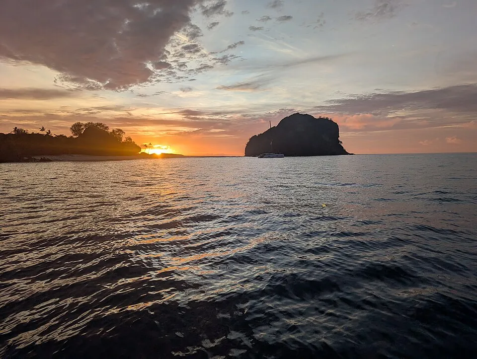 Sunset off Vanua Levu, with an island silhouetted on the horizon