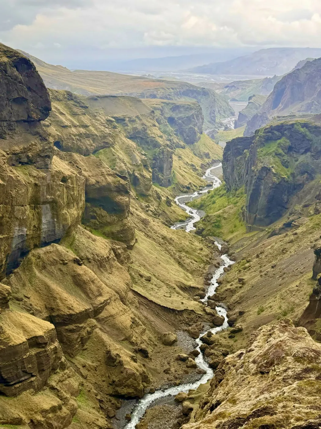 A river winding through a green highland valley