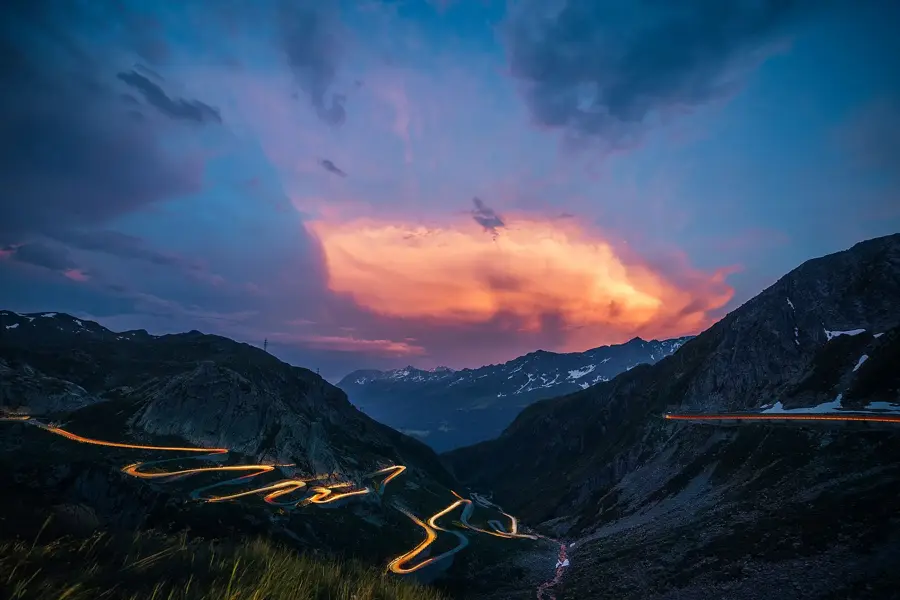 Alpine switchbacks, two cars