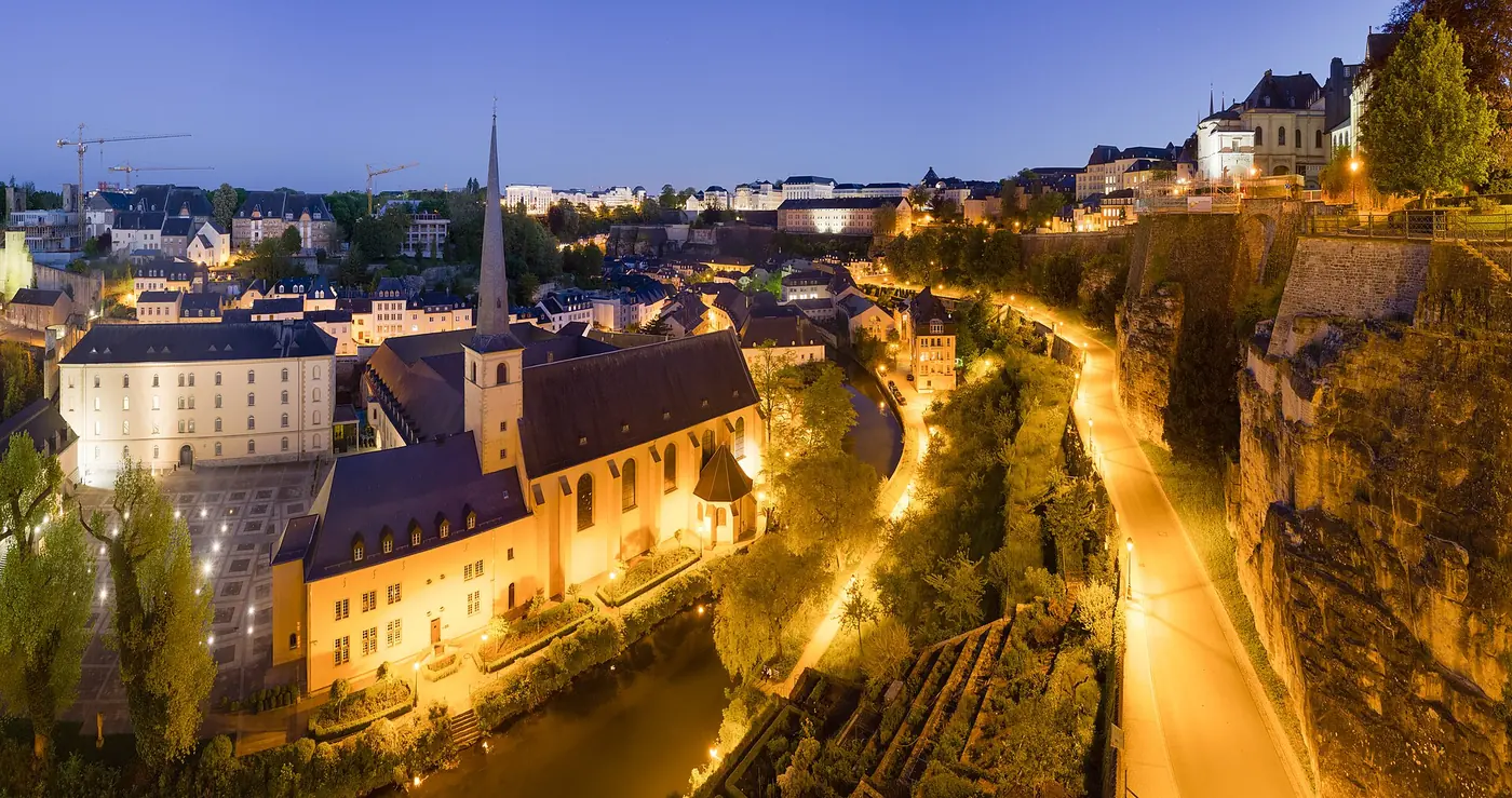 Neumünster Abbey and the Grund below the old town walls, Luxembourg, at dusk