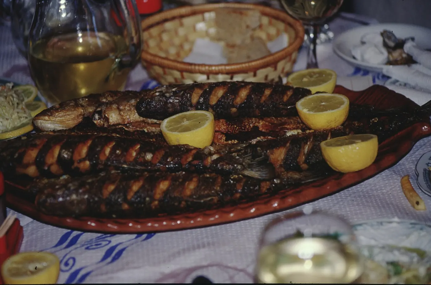 Grilled fish with lemon at a table in Albania