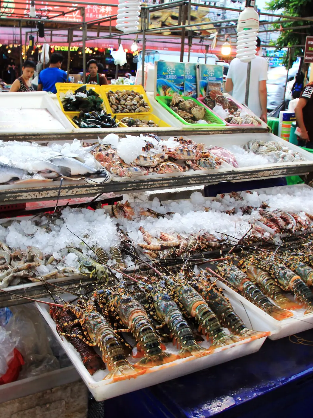 Lobsters and fish on ice at a seafood market in Patong