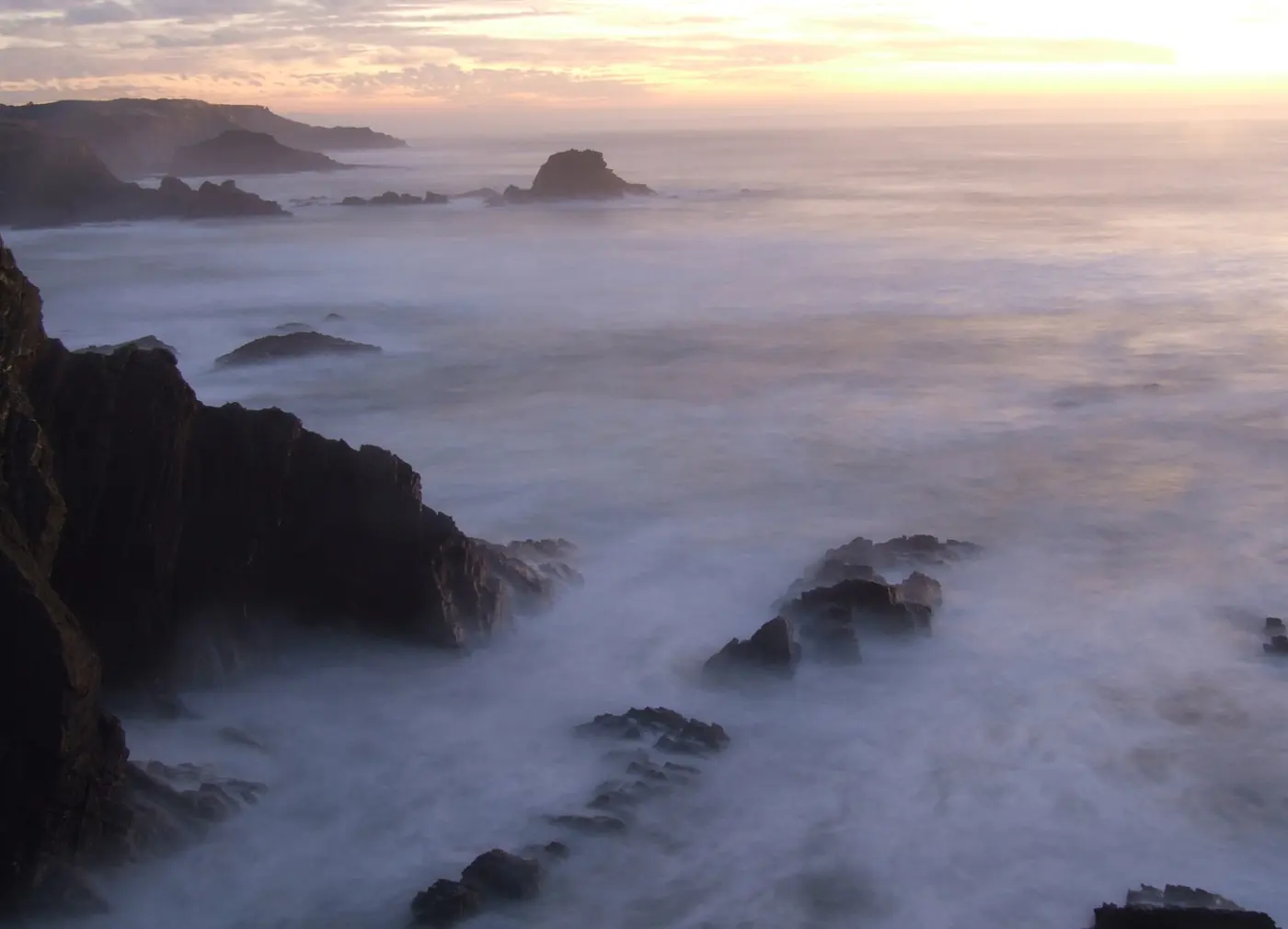 Rocks and surf at Zambujeira do Mar at dusk